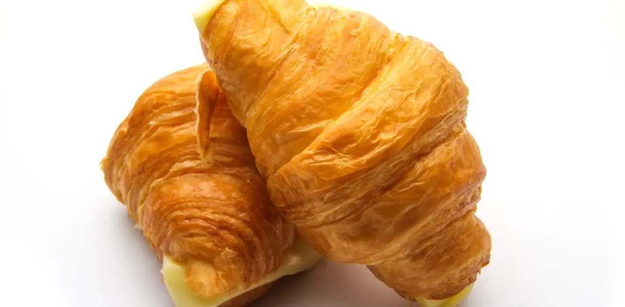 Croissant captions photo of two croissants.