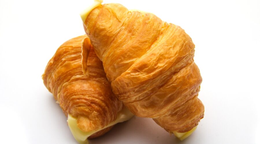Croissant captions photo of two croissants.