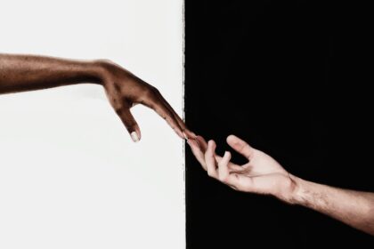 Photo for black and white captions for Instagram of two hands holding with a black and white background.