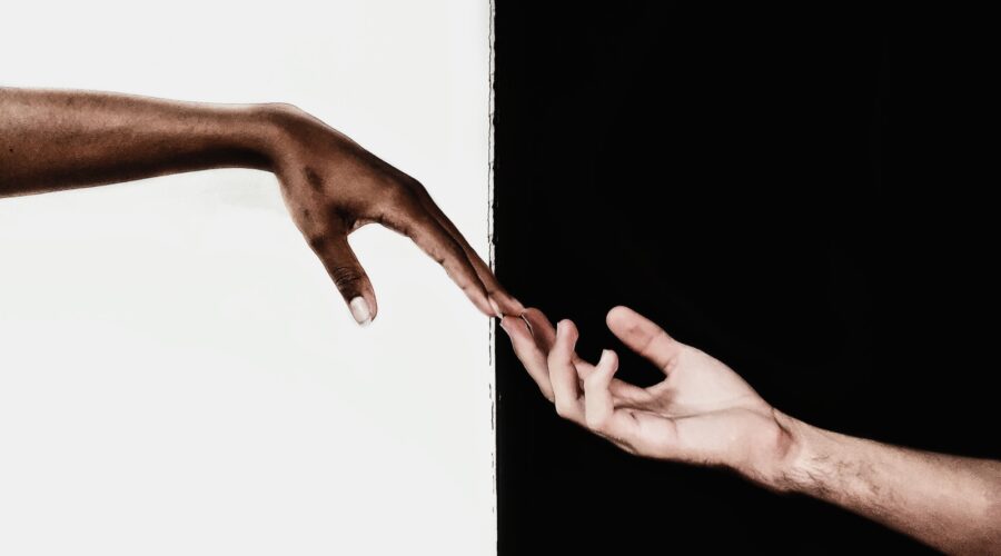 Photo for black and white captions for Instagram of two hands holding with a black and white background.