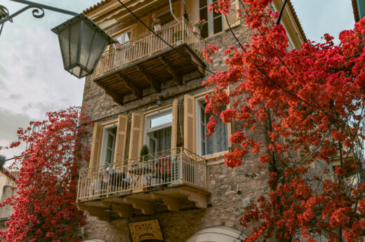 Beautiful building surrounded by bougainvillea in Nafplio, Greece.